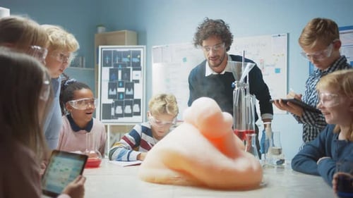 Elementary School Chemistry Classroom: Enthusiastic Teacher Teaches Diverse Group of Children Shows