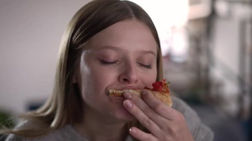 Blonde Woman Eats Pizza and Spoonful of Food