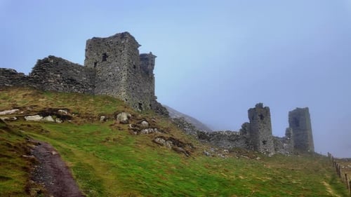The trail to the castle romantic ruins of castle Head appears out of the winter mist mystical Irish