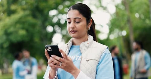 Phone, smile and volunteer woman in park for charity, community outreach or donation update