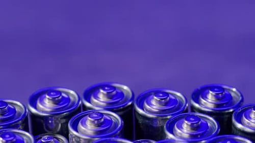 Silver Batteries AA and AAA in Neon Light Closeup DoubleA Battery is a Standard Size Single Cell