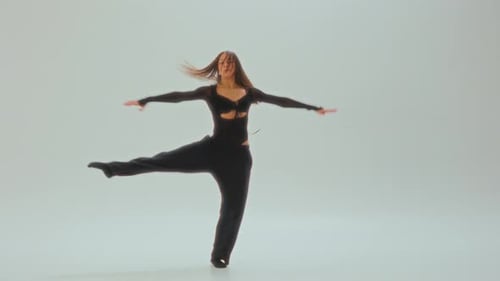 Woman Dancing in Fashionable Black Clothing