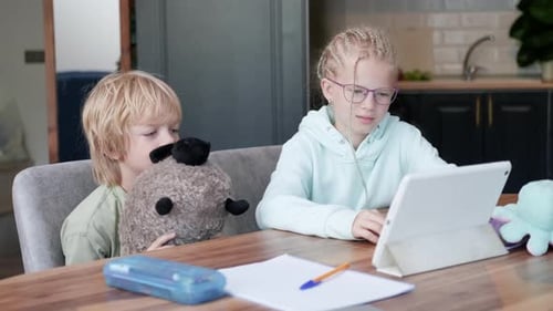 Online School Class Siblings Pupils Boy and Girl Learning Together Remotely Online at Home Looking