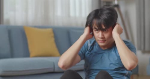 Close Up Of Athletic Fit Asian Man In Sports Clothes Doing Abdominal Crunch Exercises At Home
