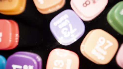 Multi-colored markers with the name of the colors on the lids. Camera inside the bag. Dolly slider e