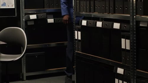Man Reviews Documents in Organized Workplace Office