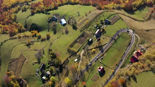 Aerial view autumn countryside winding road and driving cars by drone
