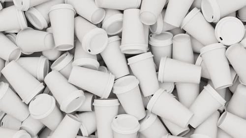Pan Over a Pile of Disposable White Coffee or Tea Plastic Cups Fly Over Set of Many Cups for a Cafe