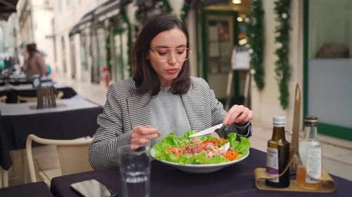 Woman Enjoying Healthy Salad at Outdoor Cafe