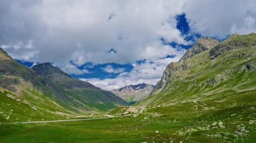 The Swiss Alps in Summer are an Incredible Natural Landscape with Clouds Hanging Over the Mountains