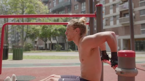 Athletic Man Doing Tricep Dips Exercise at Street Gym