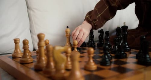 Close Up of Hands of Small Girl Play with Wooden Figurines of Chess Smart Kid