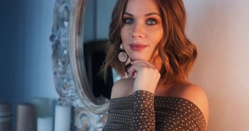 Elegant Woman Posing Fashionably Near Mirror