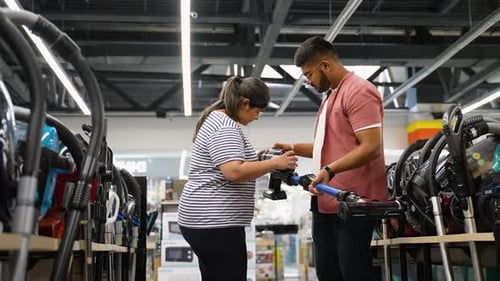 Indian Couple Buying New Vacuum Cleaner at Tech Store for New Home