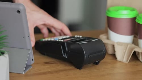 Close Up Woman is Buying Coffe in Coffeeshop and Paying with Smartphone Making Contactless Payment