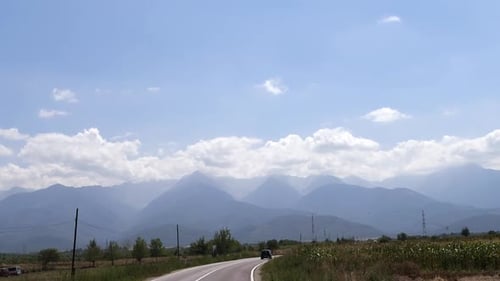Cinematic View of the mountains from the car window while driving.Summer trip.