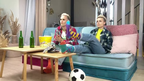 Friends Relaxing on Couch Watching Television Inside Home