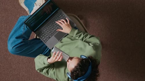 Person Drinks Soda While Coding on Laptop