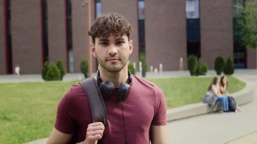 Portrait of male university student standing outside the university campus. Shot with RED helium cam