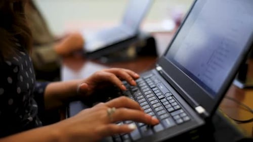 Adult Typing on Laptop Keyboard at Work