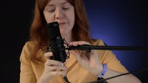 Woman Setting Microphone before Podcast