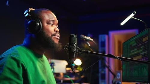 Bearded Man Sings Into Microphone in Recording Studio
