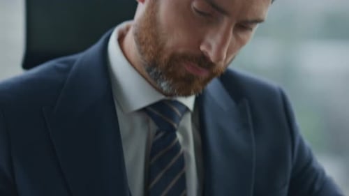 Confident Investor Signing Business Papers with Pen Sitting in Office Close Up