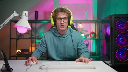 Young Adult with Headphones Using Computer