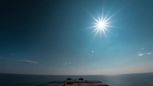 Hyperlapse of a sea large cargo ship sailing through ocean water with containers druring day, night.