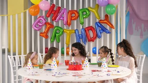 Kids Enjoying Birthday Party with Cake and Decorations