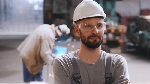 Factory Worker Wearing Safety Glasses and Hard Hat