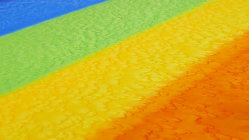 Top view of striped fabric hand-dyed in rainbow colors. Color gradients and textile texture close-up