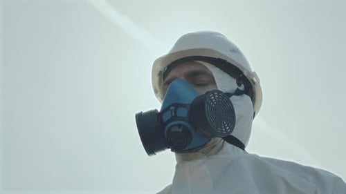 Person in Hazmat Suit with Gas Mask