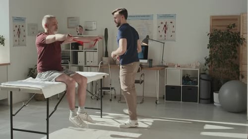 Patient Exercising with Rubber Band at Hospital