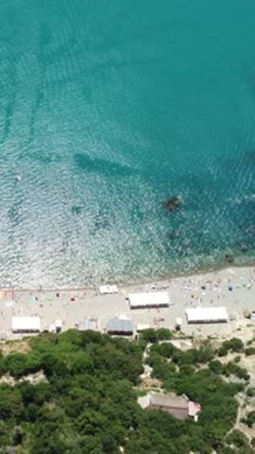 Aerial View on Summer Beach Swimming People in Sea Bay with Transparent Blue Water and Volcanic