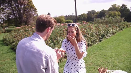 Woman Accepts Marriage Proposal in Romantic Garden Setting