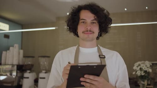 Smiling Barista Taking Order in Coffee Shop