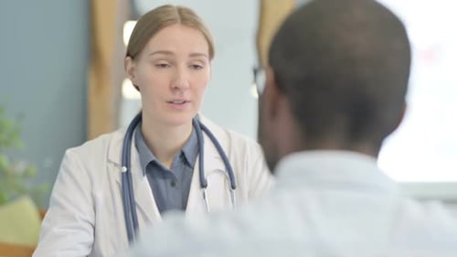 Doctor Speaking to Patient During Medical Consultation