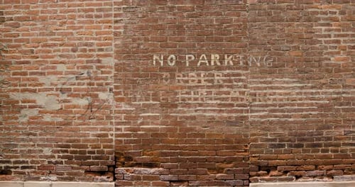 Brick Wall with Painted No Parking Sign