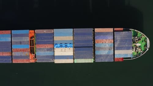 Aerial Topdown View of a Passing Container Ship with a Cargo of Containers