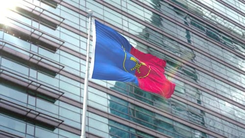 Waving Flag on Pole in Front of Modern Corporate Building