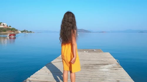 Child Look at Yacht From Pier
