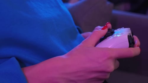 Close Up Shot of Young Woman Playing Game Online at Home in Neon Light