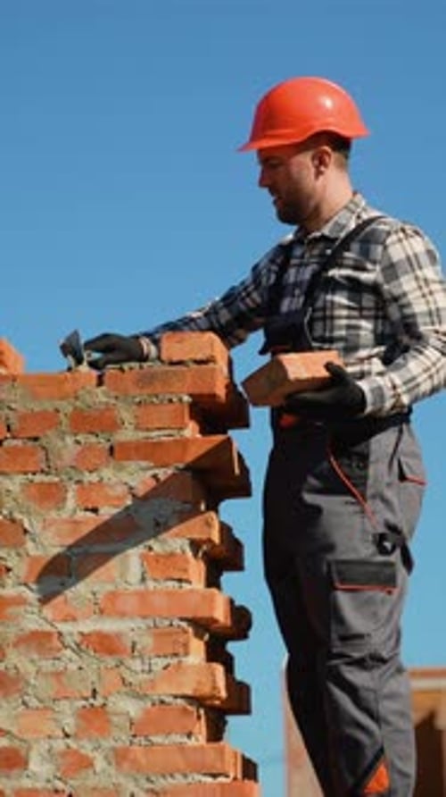 Builder Constructing a Brick Duplex Townhouse