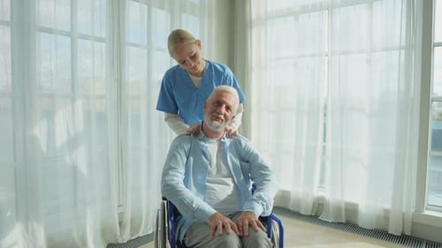 Senior Man Receives Gentle Massage from Young Adult
