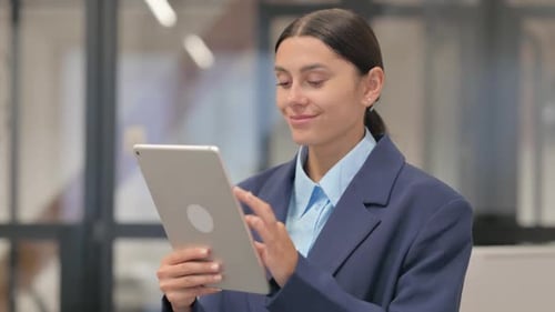 Businesswoman Using Tablet Device in Modern Office