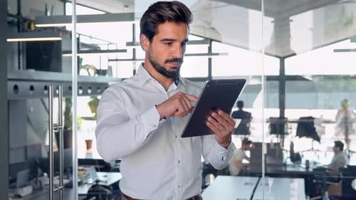 Busy Young Latin Business Man Manager Using Tablet Standing in Office