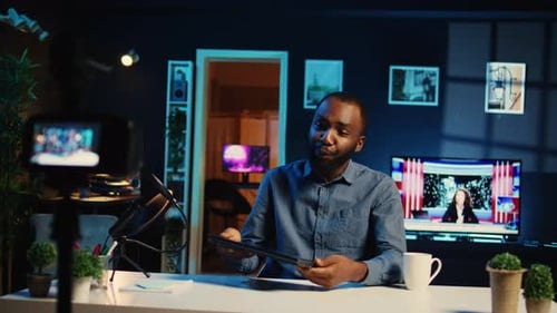 Man Recording Video With Laptop at Desk