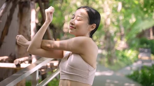 Woman Stretching Arms in Tropical Green Park