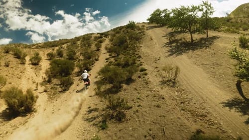 Motorbiker Rides Vehicle Leaving Dust Trail